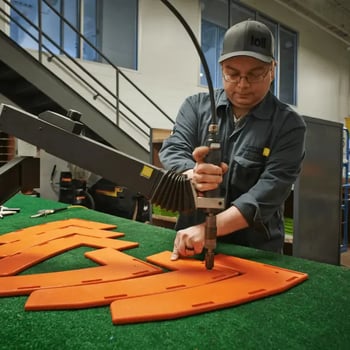 Worker inserting fastener in chair assembly